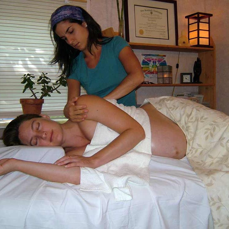 Dana Scarano give a prenatal massage.