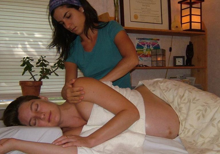 Dana Scarano giving a prenatal massage in a client's home